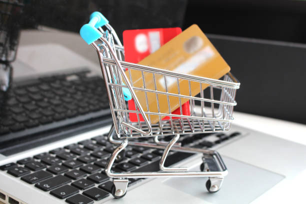 istock Credit cards in shopping cart on computer keyboard 1156422710
