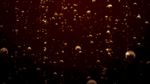 Transparent bubbles go up underwater over coca-cola background