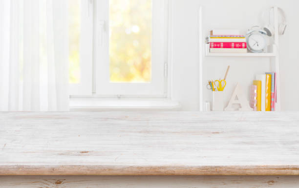 istock Rustic wood table for product display over blurred schooler room 1156423128