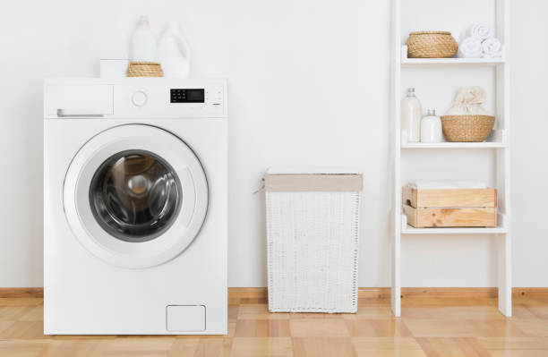 Laundry room interior with washing machine and shelf near wall