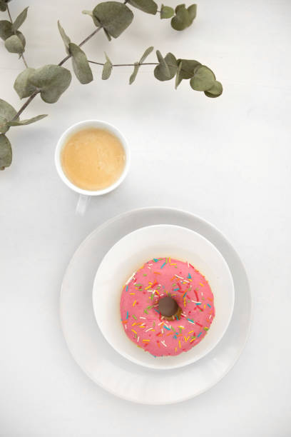 istock Plant twig near coffee and donut 1156423265