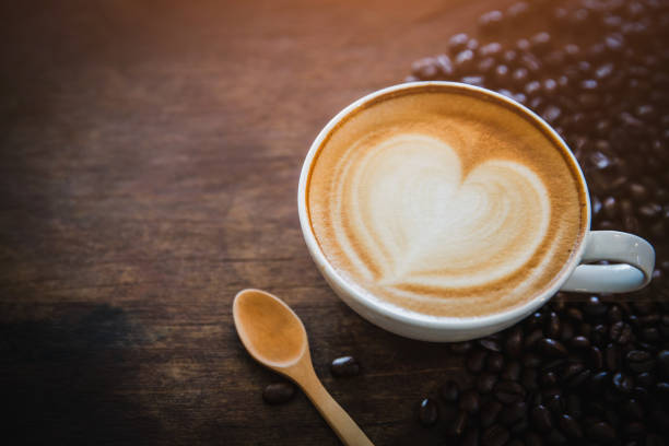istock coffee latte with coffee beans  on dark background, top view 1156425429