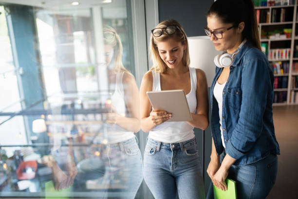 istock Group of friends studying together at university campus 1156425578