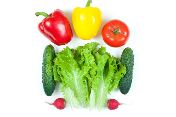 istock Fresh colorful organic vegetables captured from above (top view, flat lay) isolated on a white background. Layout with free (copy) space. Healthy food conception. Ingredients for salad 1156426161