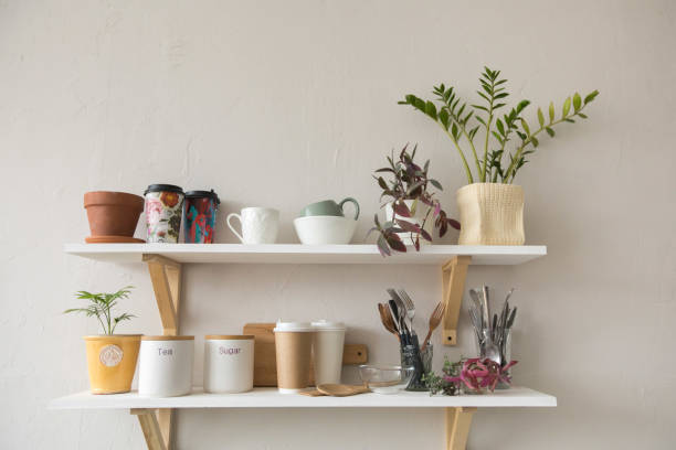 Pots and dishware on shelves stock photo