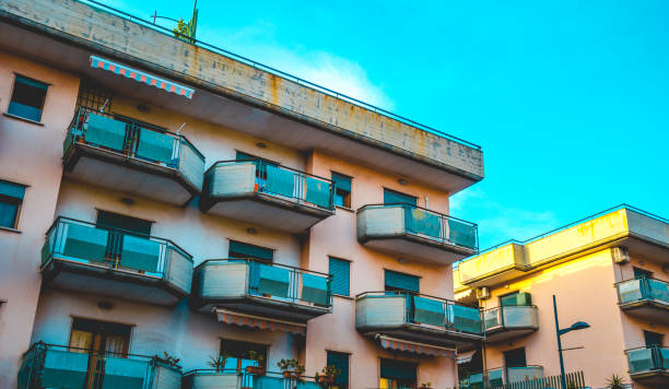 istock Pink urban apartment block with balconies 1156427080