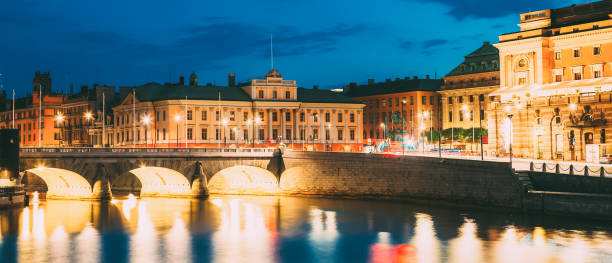 istock Bridge Over River In City At Night 1156428294