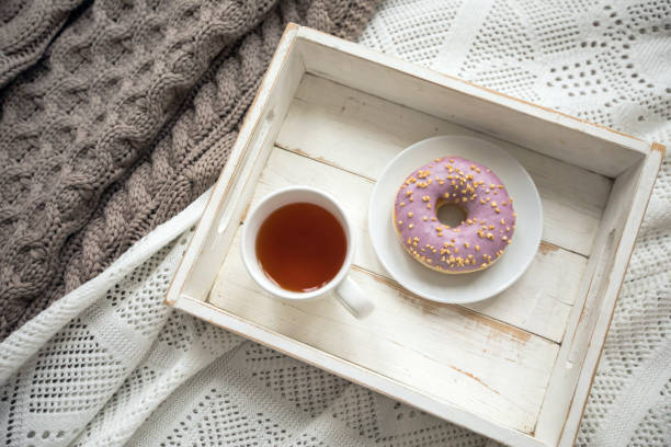 istock Wooden tray with tea and served doughnut 1156429256