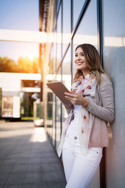 istock Beautiful brunette girl using tablet for work, freelance, blogging, studying, shopping 1156429420