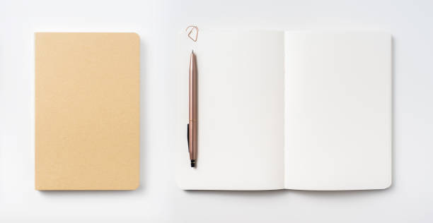 istock Top view of hardcover kraft notebook and pen 1156434731