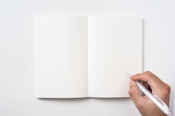 istock man hand hold pen and black notebook on background 1156434767