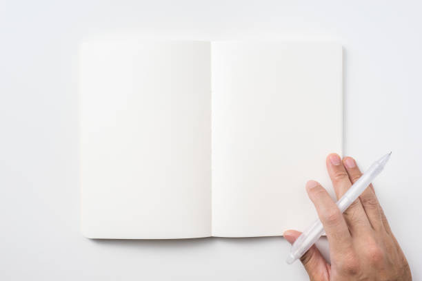 istock man hand hold pen and black notebook on background 1156434784