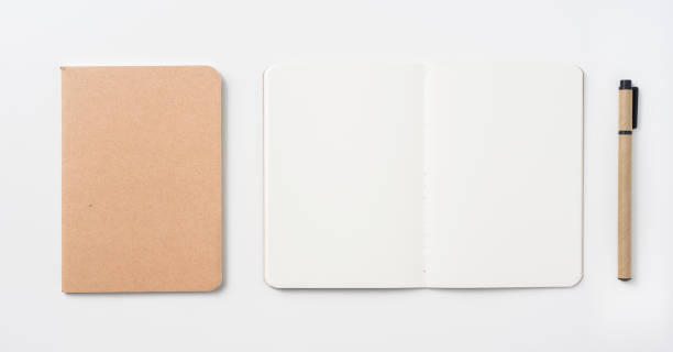 istock Top view of hardcover kraft notebook and pen 1156434944