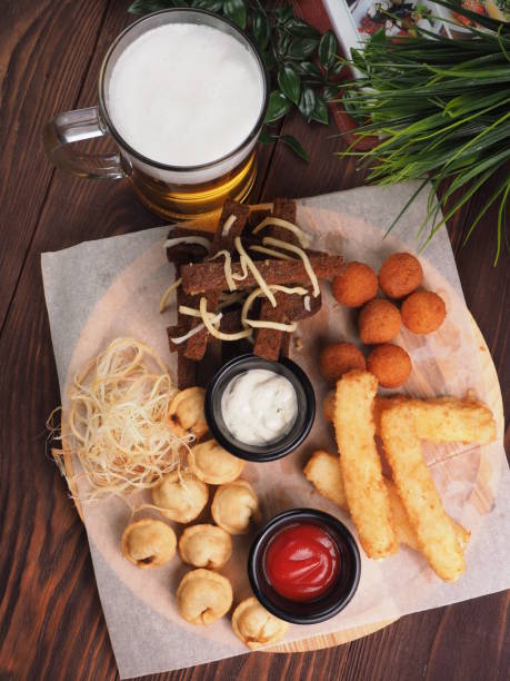 istock Big set of snacks for beer it includes fried cheese balls, pigtail cheese, fried dumplings 1156435362