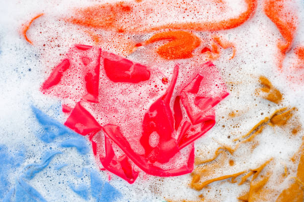 istock Color clothes soak before washing. 1156435752