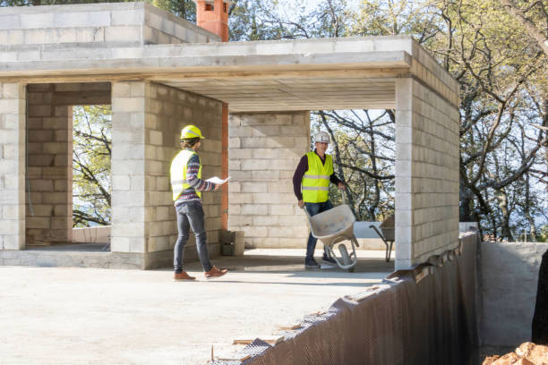 Building trades, building contractors on a house building under construction stock photo