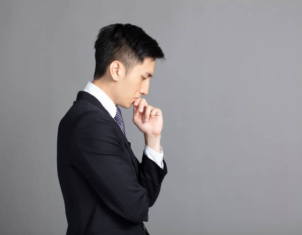 istock side view of handsome young business man thinking 1156439204