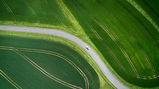 istock Winding road through agricultural area 1156440107