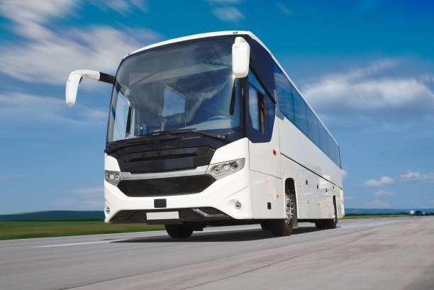 istock White Tour Bus on the Road 1156444957