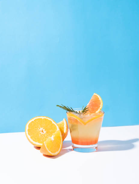 istock Cold and refreshing orange punch cocktail with orange slice on color background. summer drink. 1156445120