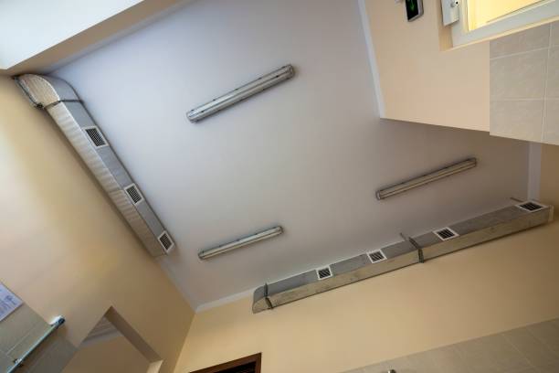 istock Industrial air duct ventilation equipment and pipe systems installed on building ceiling and walls. Comfortable workplace concept. 1156446422
