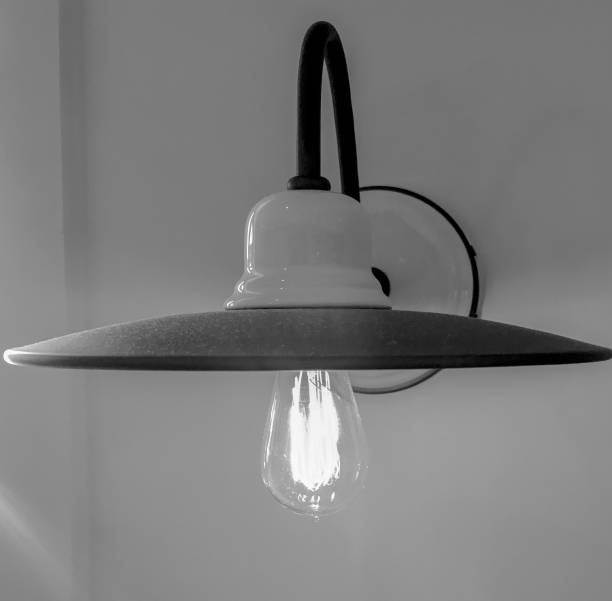 istock art deco style wall lamp fixture with clear, glowing incandescent bulb 1156448405