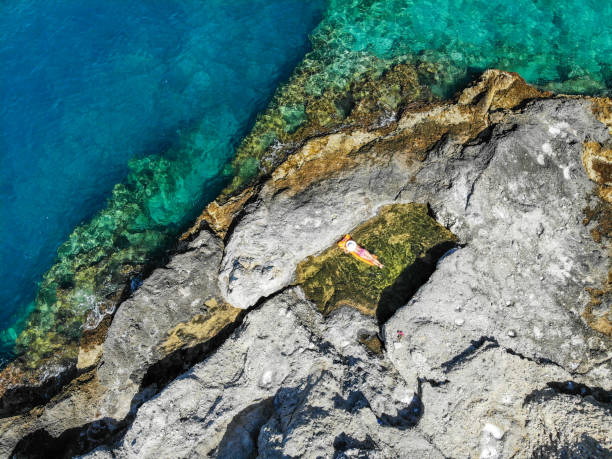 istock Woman floating in pool formed in nature. 1156448624