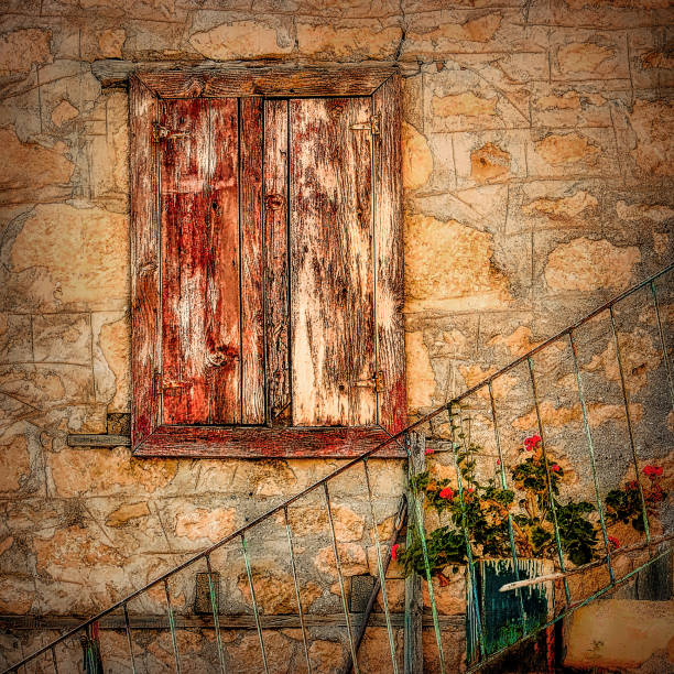 Old stone wall with old wood window and flowers in Turkey village