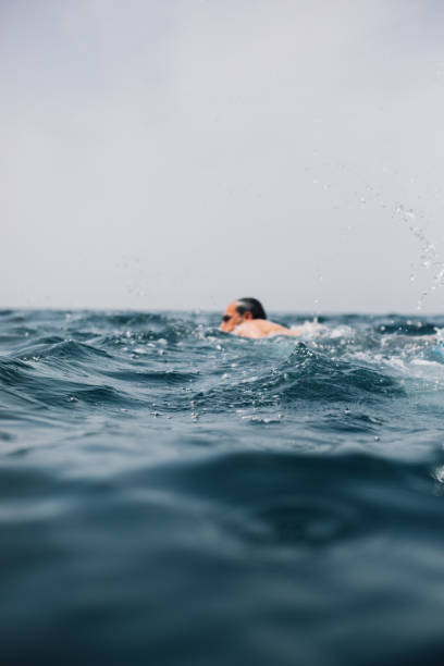 istock Man swimming in sea 1156450259