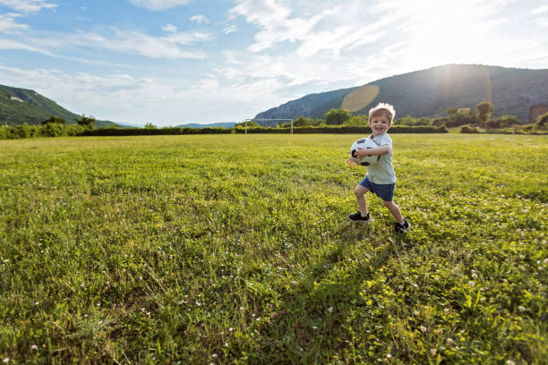 istock Little boy on the soccer field 1156450393