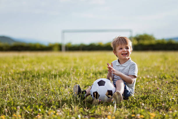 istock Little boy with soccer ball 1156450579