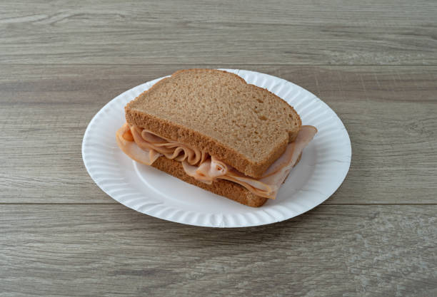 istock Thin sliced smoked turkey sandwich on a table 1156451712