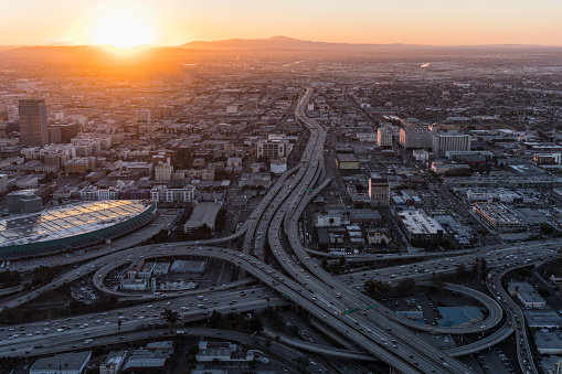 Aerial sunrise view of 10 and 110 freeway interchange ramps in downtown Los Angeles California.
