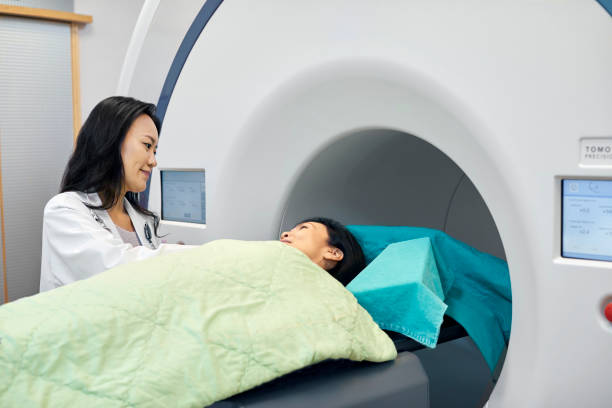 istock Female doctor looking at patient lying on scanner 1156453957