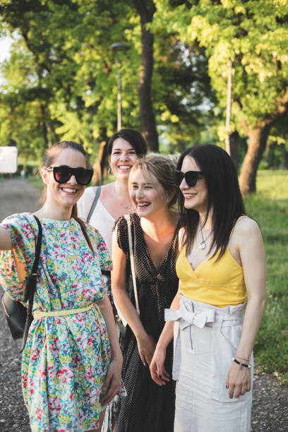 istock Four girlfriends taking selfies in nature  on a sunny day 1156454397
