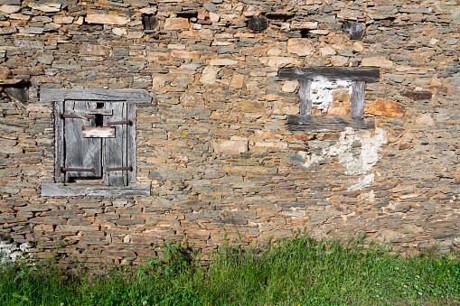 Battered window shutters of a rustic French farm building.