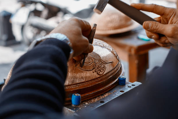 Craftsman doing engravings on a copper metal plate Craftsman doing engravings on a copper metal plate gaziantep city stock pictures, royalty-free photos & images