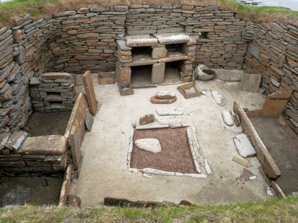 Excavated archaeological site at  Skara Brae on the Orkney Islands, Scotland An excavated room forming a part of Skara Brae, the remains of a 5000 year old neolithic settlement on the Orkney Islands Mainland in Scotland, UK. stone age stock pictures, royalty-free photos & images