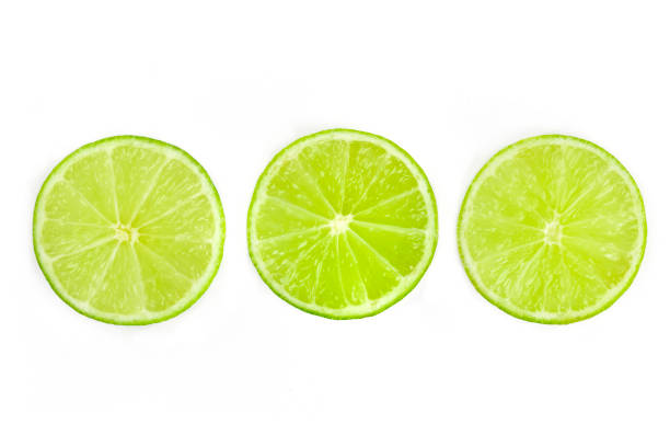 istock Three vibrant lime slices, shot from the top on a white background 1156455651