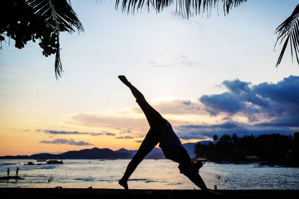 istock Caucasian woman practicing yoga at seashore 1156455693