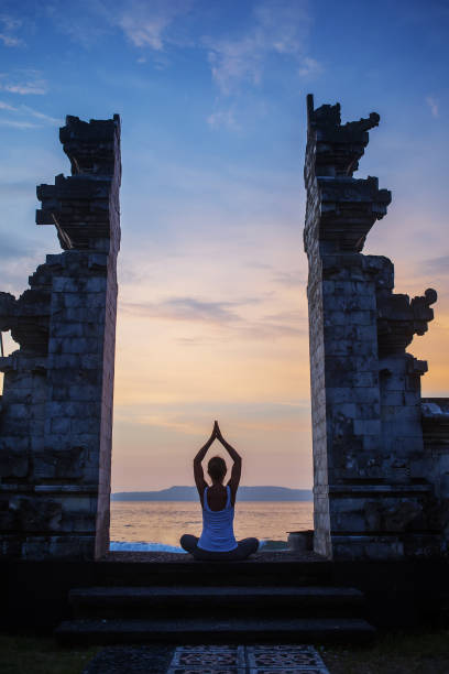 istock Caucasian woman practicing yoga at seashore 1156455718