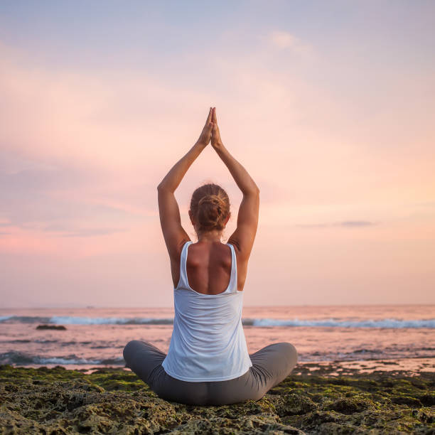 istock Caucasian woman practicing yoga at seashore 1156455735