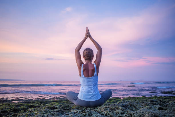 istock Caucasian woman practicing yoga at seashore 1156455763