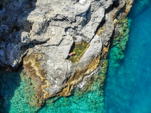 istock Woman floating in pool formed in nature. 1156455867