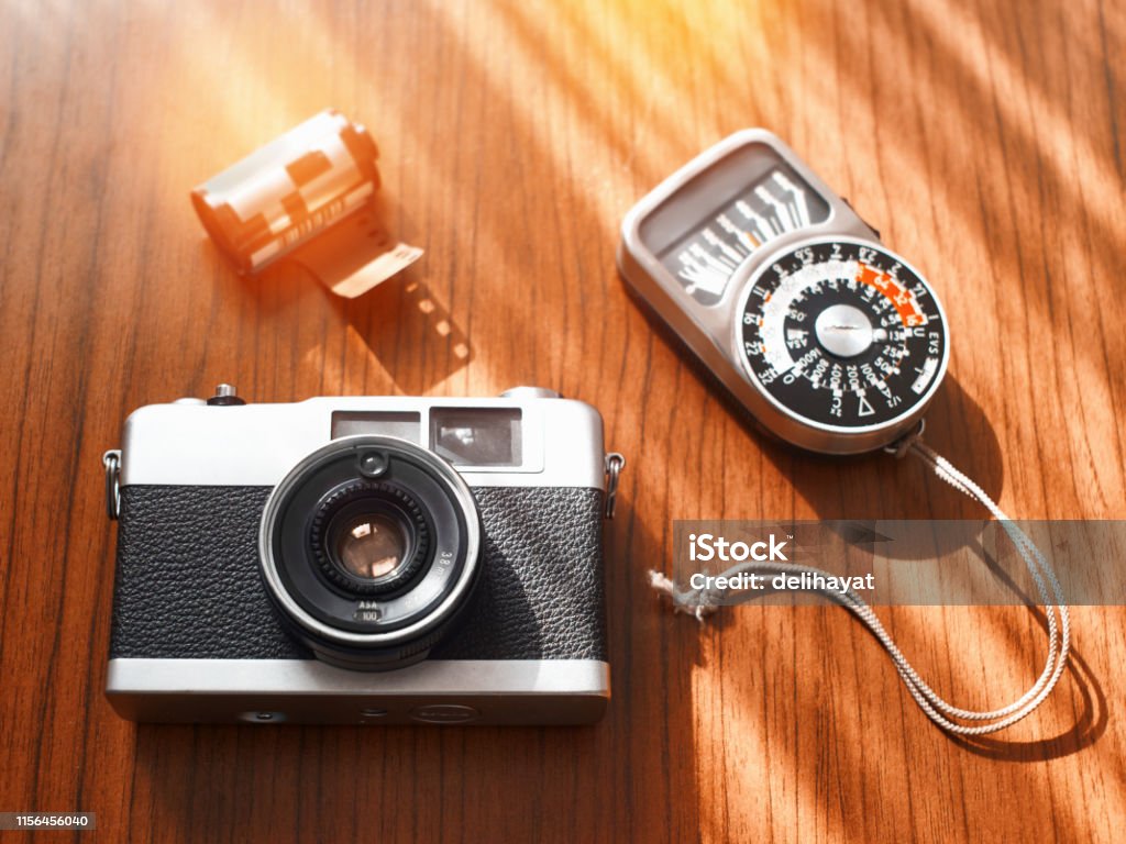 auroch Stor violin Rangefinder Film Camera With A Photographic Film And Light Meter On A  Wooden Table From High Angle View Stock Photo - Download Image Now - iStock