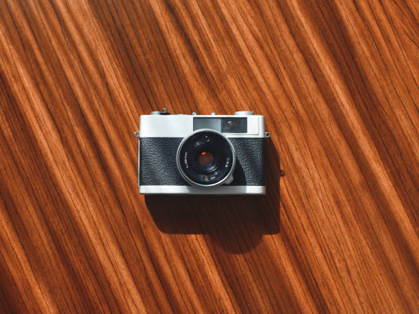 Rangefinder film camera on a wooden table from directly above