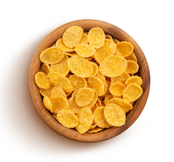 istock Corn flakes in wooden bowl isolated on white background, top view 1156456140