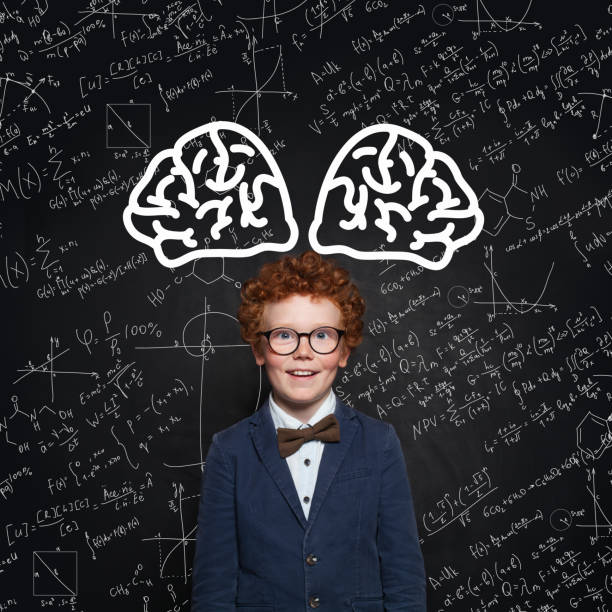istock Happy child learning science. Redhead kid on background with science formulas 1156456177