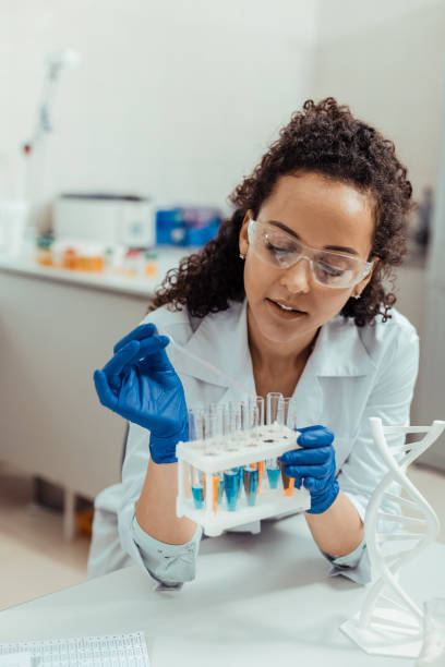 istock Nice young woman holding a test tube rack 1156456266