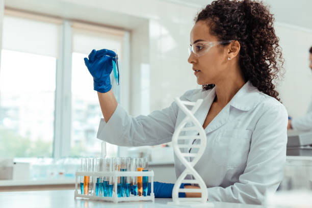 istock Nice young woman looking at the blue liquid 1156456279